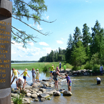 Bucket list-Minnesota Great River Road travelers walking across the Mississippi River headwaters at Lake Itasca